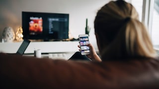 Streaming Illegal for Free: Woman Watching TV on Smartphone