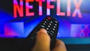 Netflix Discontinues Shuffle Play Feature: Logo on TV with Remote