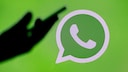WhatsApp Logo Dark Hand: Blocking Unknown Calls Symbolic Image