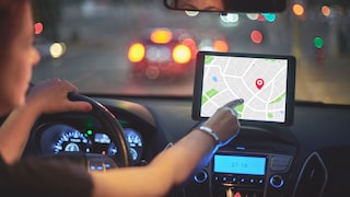 Woman Uses GPS on Car Navigation Device