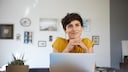 Streaming Work Symbol: Smiling Young Woman at Laptop