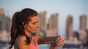 Woman with Headphones and Watch While Exercising