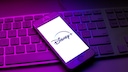 Disney+ Removes Movies and Series: Disney+ Logo on Smartphone Resting on a Keyboard