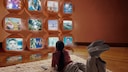 Woman in Front of Multiple Screens