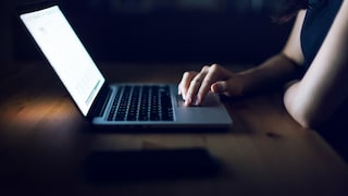 Europol Phone Email Stock Image: Woman in the Dark on Laptop