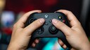 Xbox Price Increase: Someone Holds a Black Xbox Controller