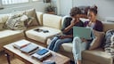 Gandalf Web Game Stock Image: Two Young People with Laptop on Sofa