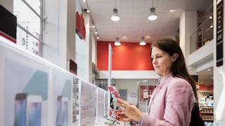 Woman buying a smartphone in a store.