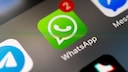 Stock Image: WhatsApp icon on a smartphone screen.