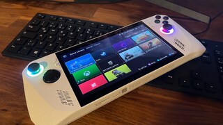 Asus ROG Ally Handheld Console Reviewed on a Wooden Table, Keyboard in the Background