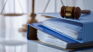 Blue binders with a gavel on the table