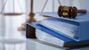 Blue binders with a gavel on the table