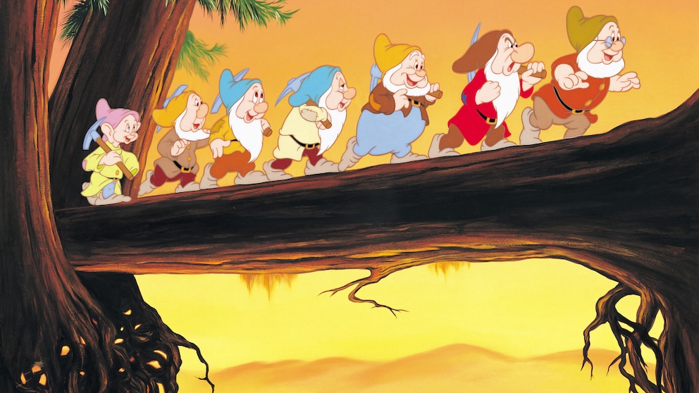 Excerpt from the Disney film "Snow White and the Seven Dwarfs," showing the dwarfs running across a log bridge.