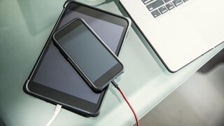 Stock image: A charging tablet with a smartphone placed on top.