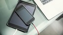 Stock image: A charging tablet with a smartphone placed on top.