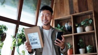 Man with Package and Smartphone in Hand