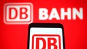 DB Route Navigator: Deutsche Bahn Logo in the Background and on Smartphone