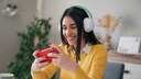 Woman Plays a Mobile Game on iPhone