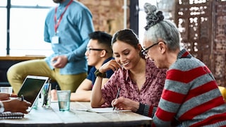 A group of people is working at a table.