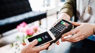 Stock Photo: Close-up of a payment transaction using a smartphone via NFC