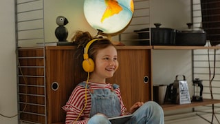 Stock Image: Little Girl with Yellow Headphones