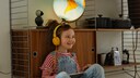 Stock Image: Little Girl with Yellow Headphones