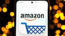 Amazon logo with a shopping cart icon on a smartphone.