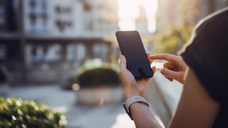 Person Uses Smartphone Outdoors