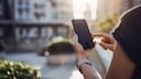 Person Uses Smartphone Outdoors