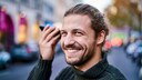 Man Holds Smartphone Horizontally to Ear