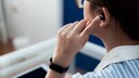 Woman Has Bluetooth Earbuds in Her Ear