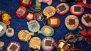 Numerous Tamagotchis on a table.