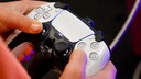 A person holds a PS5 controller in their hands.