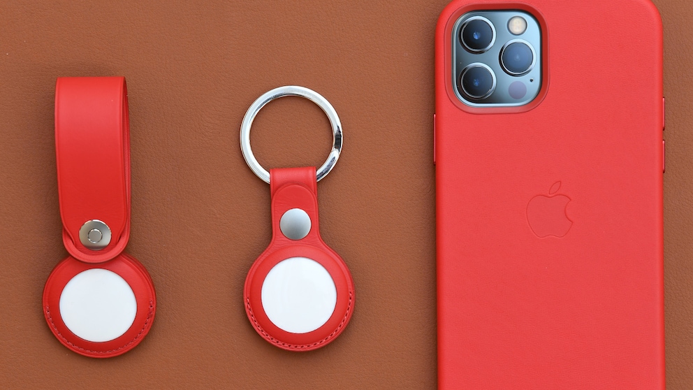 Apple AirTags next to an iPhone 12
