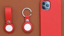 Apple AirTags next to an iPhone 12