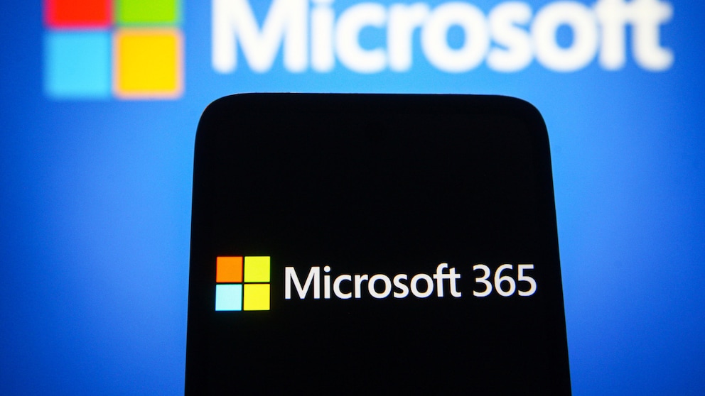 Microsoft 365 on a cell phone, with the Microsoft logo behind it