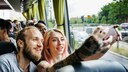 Stock Photo: Couple Takes Vacation Photo on Tour Bus