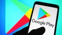 Google Play Store logo on a cell phone and in the background