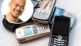 TECHBOOK editor Woon-Mo Sung next to various old push-button cell phones