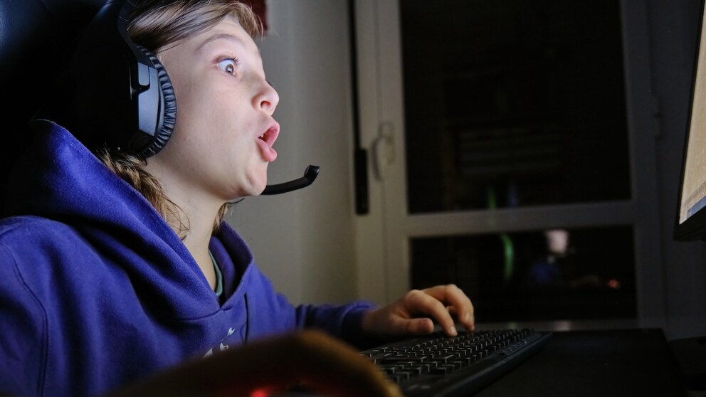Boy looks wide-eyed at the computer