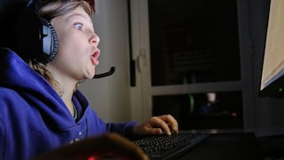 Boy looks wide-eyed at the computer