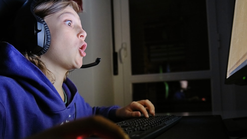 Boy looks wide-eyed at the computer