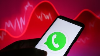 WhatsApp logo on a smartphone with a red background