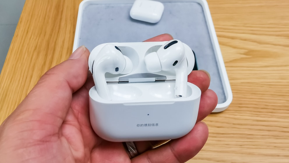 Person holding AirPods Pro in the store