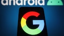 Google logo on a smartphone, behind it a logo for Android