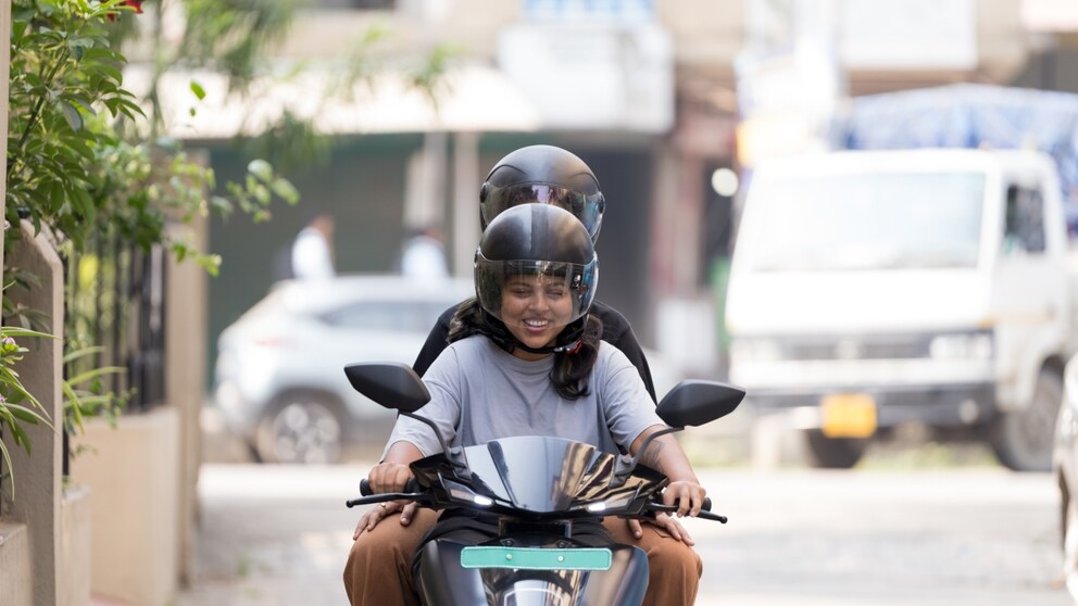 Woman with another person on an e-scooter