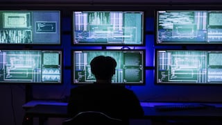 Person sits in front of several monitors