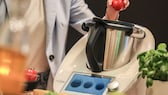 Woman operating a Thermomix TM6