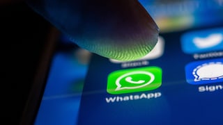 Person Presses Finger on WhatsApp on Smartphone