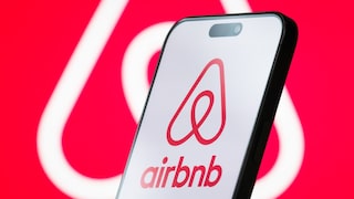 Airbnb Logo on a Smartphone and in the Background